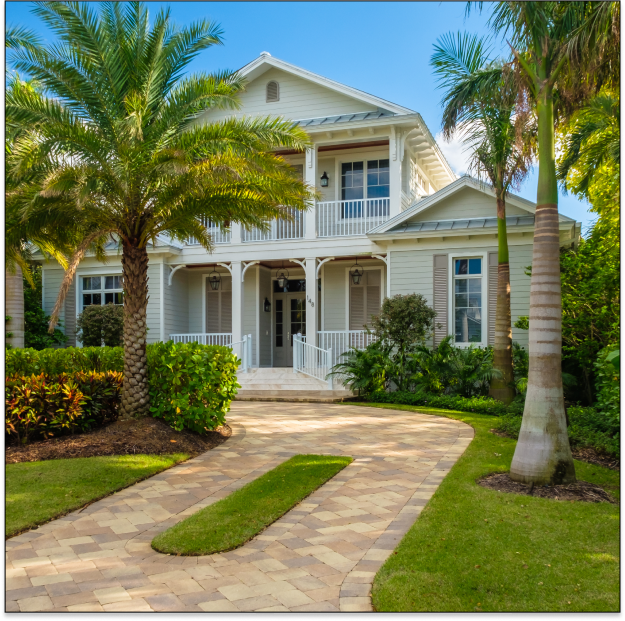 beachy, two story house with a stone driveway