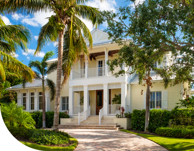 cropped beachy, two story house with a stone driveway