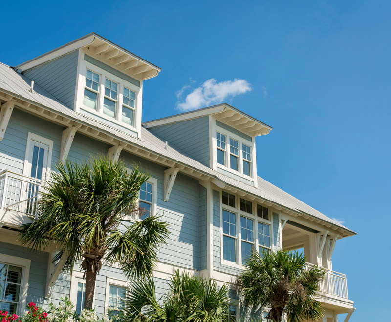 Low angle view of a house with light blue wood sidings and white trims at Destin, Florida