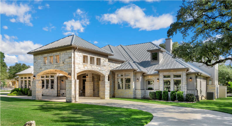 beachy, two story house with a stone driveway